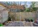 Private patio with a wooden fence, gravel, and a small seating area at 162 Lablanc Nw Way, Atlanta, GA 30327