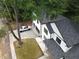 Aerial view of a white, two-story home with a dark roof and a large driveway at 2764 Midway Rd, Decatur, GA 30030