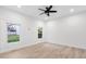 Bright bedroom with ceiling fan and two windows overlooking a green lawn and trees at 2764 Midway Rd, Decatur, GA 30030
