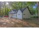 Newly renovated white two-story home with a dark roof, surrounded by lush trees at 2764 Midway Rd, Decatur, GA 30030