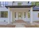 Inviting covered front porch with brick steps leading to the glass front door at 2764 Midway Rd, Decatur, GA 30030