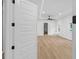 Open doorway into living room with wood floors, new lighting and bright windows at 2764 Midway Rd, Decatur, GA 30030