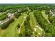 Gorgeous aerial view of a golf course with manicured fairways, lush trees, and scenic landscaping in the background at 5173 Brendlynn Dr, Suwanee, GA 30024