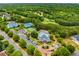 Overhead shot showcasing community amenities: pools, tennis courts, playgrounds, and manicured landscaping at 5173 Brendlynn Dr, Suwanee, GA 30024