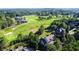 Stunning aerial view of an estate home backing onto a lush, green golf course and surrounded by mature trees at 5173 Brendlynn Dr, Suwanee, GA 30024