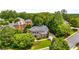 Serene aerial view of a luxurious home nestled among mature trees and manicured landscaping in a lovely neighborhood at 5173 Brendlynn Dr, Suwanee, GA 30024