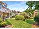 Expansive backyard features lush green grass, mature trees, patio, and access to a second-story deck at 5173 Brendlynn Dr, Suwanee, GA 30024