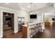 Finished basement bar with granite countertops, stainless steel appliances, and seating for three at 5173 Brendlynn Dr, Suwanee, GA 30024