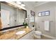 Elegant bathroom featuring granite counters, a framed mirror, and a walk-in shower at 5173 Brendlynn Dr, Suwanee, GA 30024