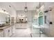 Luxury bathroom featuring a soaking tub, separate glass shower, dual vanity, and modern fixtures at 5173 Brendlynn Dr, Suwanee, GA 30024