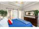 Bedroom with a tray ceiling, barn door to the en-suite bathroom, and a dark dresser at 5173 Brendlynn Dr, Suwanee, GA 30024