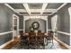 Dining room showcasing a coffered ceiling, wood floors, and a wooden table with seating for six at 5173 Brendlynn Dr, Suwanee, GA 30024