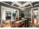 Elegant dining room with decorative ceiling, wooden table with 6 chairs and view to the outdoor garden at 5173 Brendlynn Dr, Suwanee, GA 30024