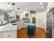 Open kitchen with granite countertops, a central island, stainless steel appliances, and hardwood floors at 5173 Brendlynn Dr, Suwanee, GA 30024