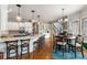 Open kitchen with an island, counter seating, and a breakfast nook with a table and chairs at 5173 Brendlynn Dr, Suwanee, GA 30024