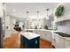 Kitchen with stainless steel appliances, a large island and open access to a dining room and living room at 5173 Brendlynn Dr, Suwanee, GA 30024