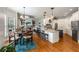 Spacious open-concept kitchen and living room with stainless steel appliances, large island, and dining area at 5173 Brendlynn Dr, Suwanee, GA 30024