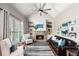 Cozy living room with stone fireplace, built-in shelving, a leather sofa and a vaulted ceiling at 5173 Brendlynn Dr, Suwanee, GA 30024