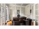 Bright home office featuring hardwood floors, wainscotting, French doors and natural light from the windows at 5173 Brendlynn Dr, Suwanee, GA 30024