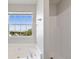 Bright bathroom featuring a tub and window providing natural light at 139 Palmetto St, Locust Grove, GA 30248