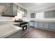 Modern kitchen with stainless steel appliances, gray cabinets, and beautiful wood floors at 139 Palmetto St, Locust Grove, GA 30248