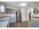 Spacious kitchen with stainless steel appliances, wood floors, and gray cabinets at 139 Palmetto St, Locust Grove, GA 30248