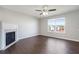 Bright living room with fireplace, ceiling fan, and lots of natural light at 139 Palmetto St, Locust Grove, GA 30248