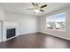 Bright living room with fireplace, ceiling fan, and lots of natural light at 139 Palmetto St, Locust Grove, GA 30248