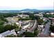 A beautiful aerial view of the city with a crowd of people in a park and a mountain range in the background at 2623 Lone Oak Nw Trl, Kennesaw, GA 30144