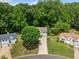 Aerial view of a two-story home surrounded by lush greenery in a peaceful neighborhood setting at 2623 Lone Oak Nw Trl, Kennesaw, GA 30144