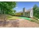 Backyard with mature trees, a walkway, and a patio area for outdoor entertaining at 2623 Lone Oak Nw Trl, Kennesaw, GA 30144