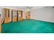 Large rec room featuring eye catching green carpet, cabinets, and multiple entryways at 2623 Lone Oak Nw Trl, Kennesaw, GA 30144