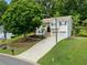 Suburban two-story home with manicured lawn, stone accents, black shutters, and a two-car garage at 2623 Lone Oak Nw Trl, Kennesaw, GA 30144