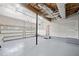 Spacious three car garage with painted floor, exposed rafters, and utility door to interior at 2623 Lone Oak Nw Trl, Kennesaw, GA 30144