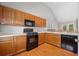 Functional kitchen featuring wood cabinets, white countertops, and modern black appliances at 2623 Lone Oak Nw Trl, Kennesaw, GA 30144