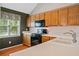 Cozy kitchen featuring ample cabinet space, white counters, and updated black appliances at 2623 Lone Oak Nw Trl, Kennesaw, GA 30144