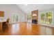Spacious living room with fireplace, hardwood floors, lots of windows, and open to breakfast bar area at 2623 Lone Oak Nw Trl, Kennesaw, GA 30144