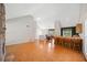 Open-concept living space featuring hardwood floors, a stone fireplace, and a bar-style kitchen counter at 2623 Lone Oak Nw Trl, Kennesaw, GA 30144