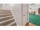 Carpeted stairs leading to basement rec room featuring bright green carpeting at 2623 Lone Oak Nw Trl, Kennesaw, GA 30144