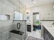 Modern bathroom featuring a glass enclosed shower with marble tile, bench, and a view to the walk-in closet at 107 W Point Trl, Woodstock, GA 30189