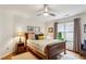 Cozy bedroom featuring natural light, hardwood floors, and neutral tones create a relaxing retreat at 107 W Point Trl, Woodstock, GA 30189