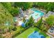 Aerial view showcasing a community pool with slides, a ' area, and a tennis court, great for Gathering fun and recreation at 107 W Point Trl, Woodstock, GA 30189