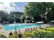 Community pool surrounded by comfortable lounge chairs, umbrellas, and lush greenery for relaxation and leisure at 107 W Point Trl, Woodstock, GA 30189