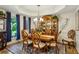Bright dining room showcasing a large window, elegant lighting, and a wooden dining set at 107 W Point Trl, Woodstock, GA 30189