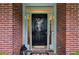 Elegant front door with decorative wreath, sidelights and brick surround, offering a warm welcome at 107 W Point Trl, Woodstock, GA 30189