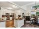 Bright kitchen features white cabinets, stainless steel appliances, granite countertops, and a cozy breakfast nook at 107 W Point Trl, Woodstock, GA 30189