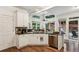 Kitchen features white cabinets, granite countertops, stainless appliances, and a cozy breakfast nook with backyard access at 107 W Point Trl, Woodstock, GA 30189