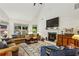 Inviting living room with high ceilings, a cozy fireplace, and large windows overlooking the backyard at 107 W Point Trl, Woodstock, GA 30189