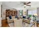 Bright and inviting living room featuring hardwood floors, fireplace, built-in shelving, and lots of natural light at 107 W Point Trl, Woodstock, GA 30189