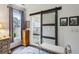 Main bathroom featuring a sliding glass door leading to a tiled shower, bench, and storage niche at 107 W Point Trl, Woodstock, GA 30189